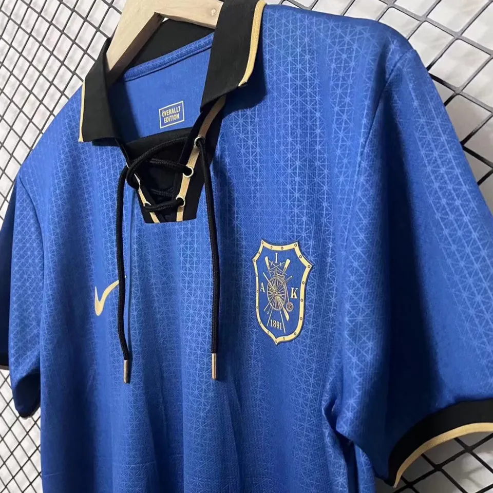 AIK cuptröja 2026 framsida vinklad – blå med guld AIK emblem 1891